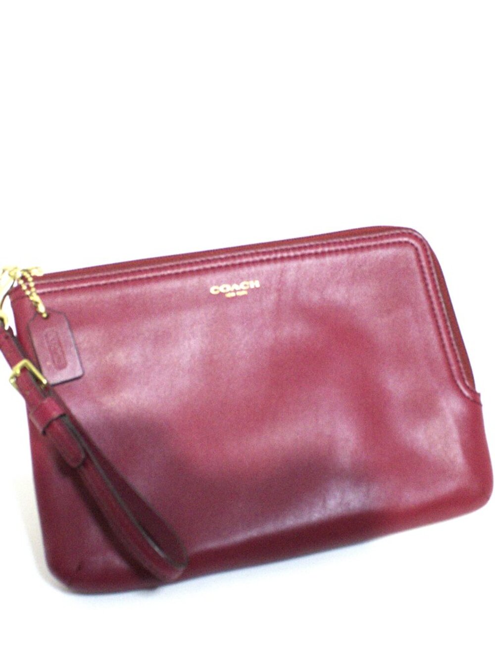 Coach, Burgundy Wristlet with an adjustable strap, Zip Closure, Gold Hardware